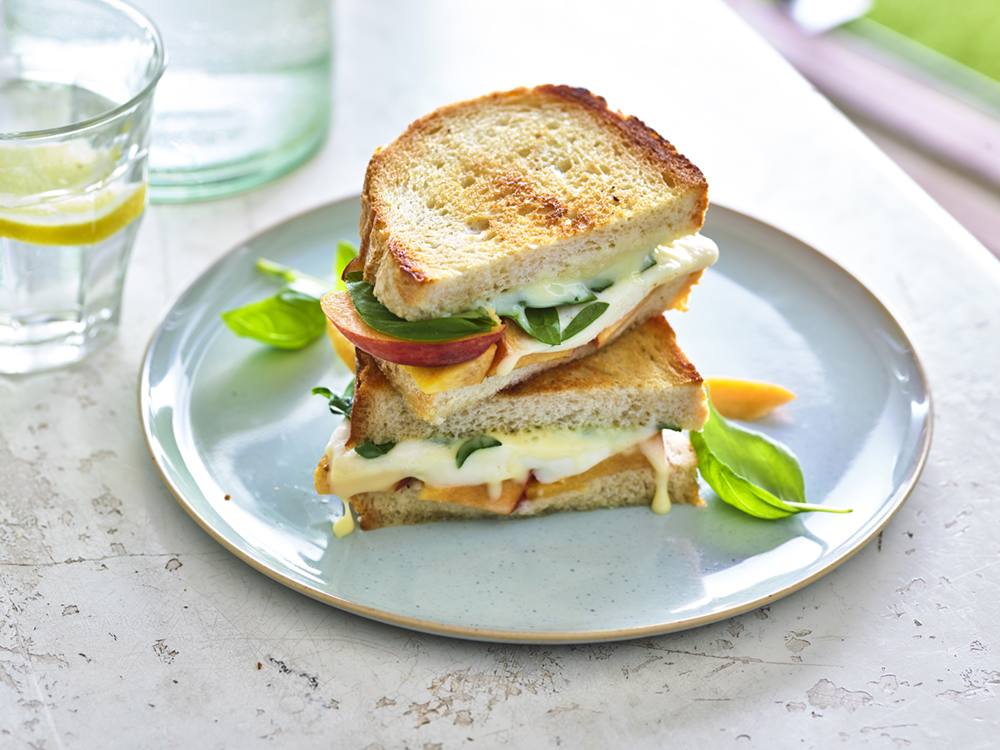 The classic tricolor Italian salad gets a summery sandwich twist with the addition of sweet peaches and bright balsamic vinegar.